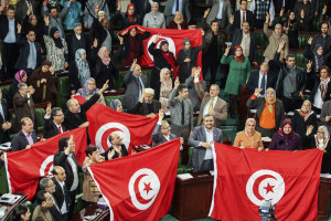 FILE - In this Sunday, Jan. 26, 2014 file photo, members of the Tunisian National Constituent Assembly celebrate the adoption of the new constitution in Tunis, Tunisia. A Tunisian democracy group won the Nobel Peace Prize on Friday for its contributions to the first and most successful Arab Spring movement. The Norwegian Nobel Committee cited the Tunisian National Dialogue Quartet "for its decisive contribution to the building of a pluralistic democracy" in the North African country following its 2011 revolution. (AP Photo/Aimen Zine, File)